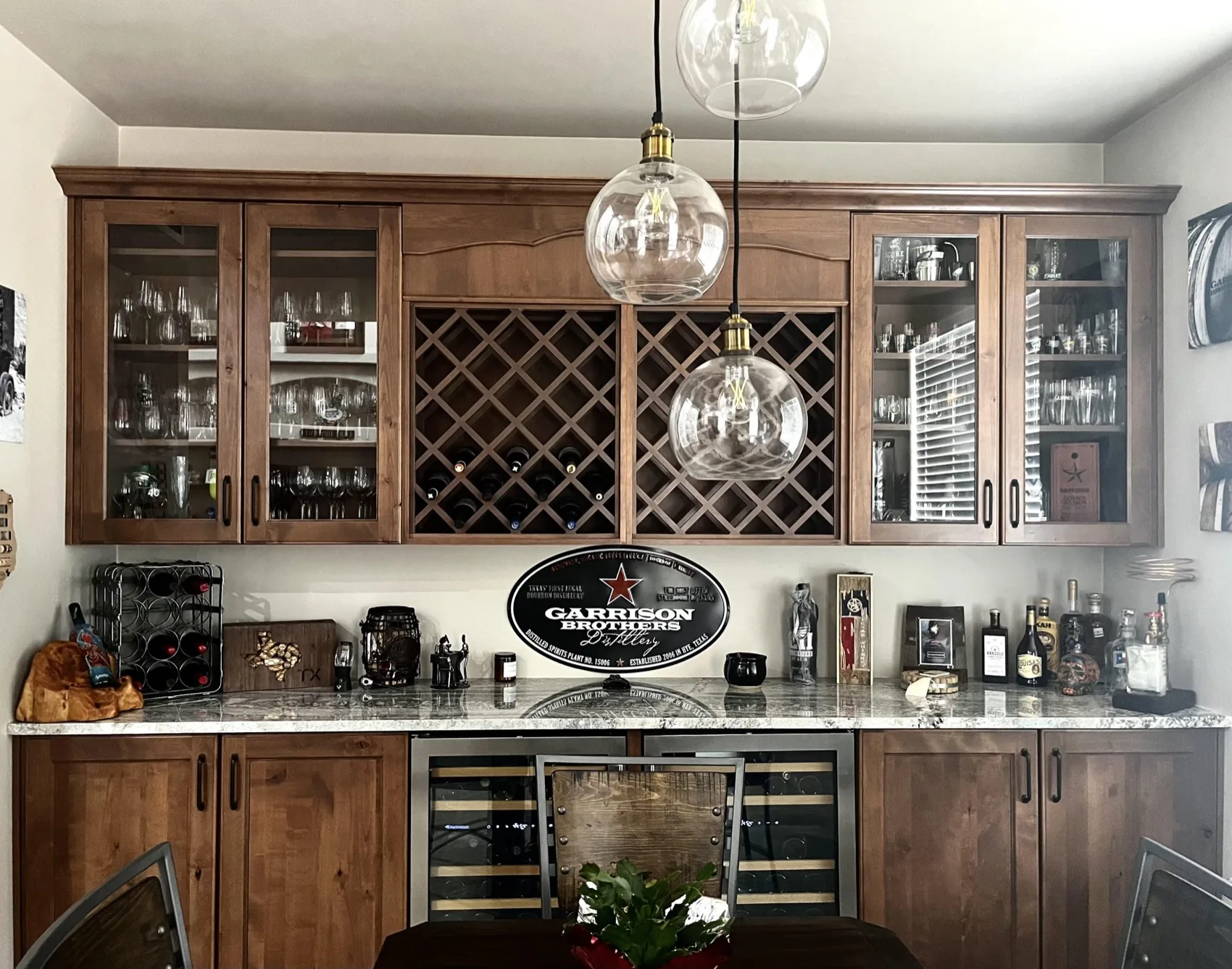 Walnut wet bar with a lattice wine rack and glass door cabinets