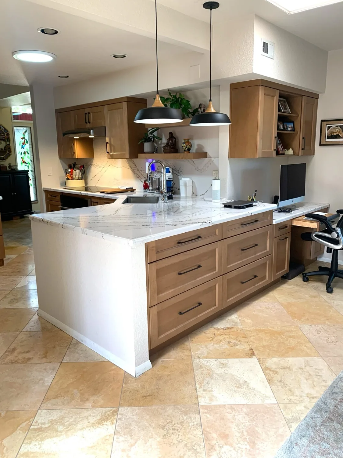Kitchen peninsula in white oak with a stone waterfall edge